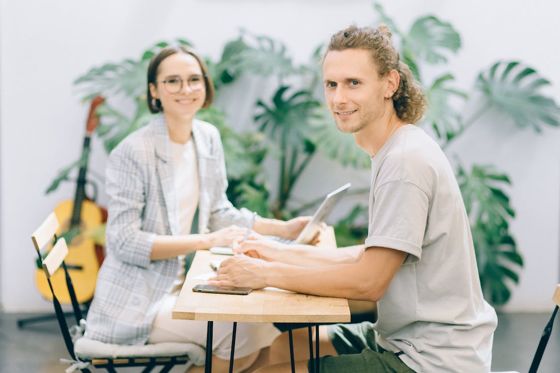 Free Woman in White Shirt Sitting Beside Woman in White Shirt Stock Photo
