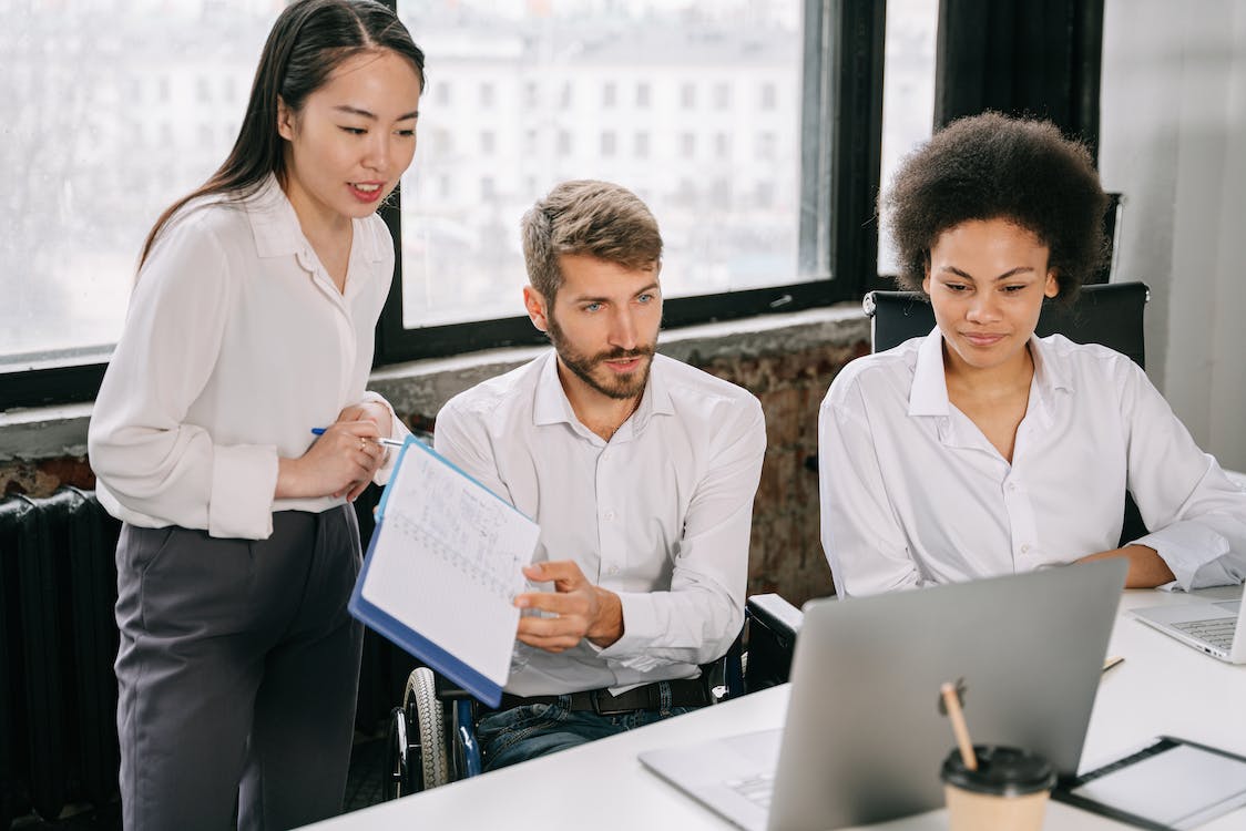 Free Group Presenting in Front of the Laptop Stock Photo
