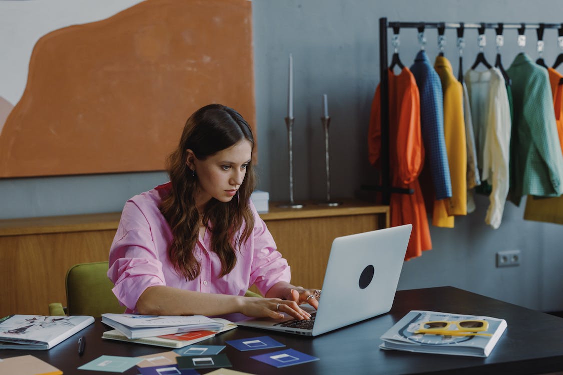 Free Woman in Pink Long Sleeve Shirt Using Macbook Stock Photo
