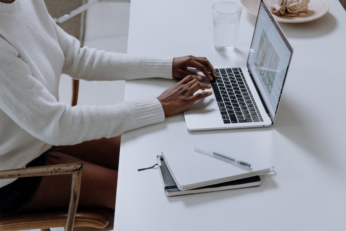 Free Person in White Long Sleeve Shirt Using Macbook Pro Stock Photo