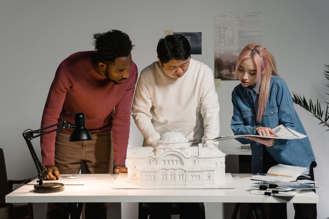 Free Three People Collaborating on a Project Stock Photo