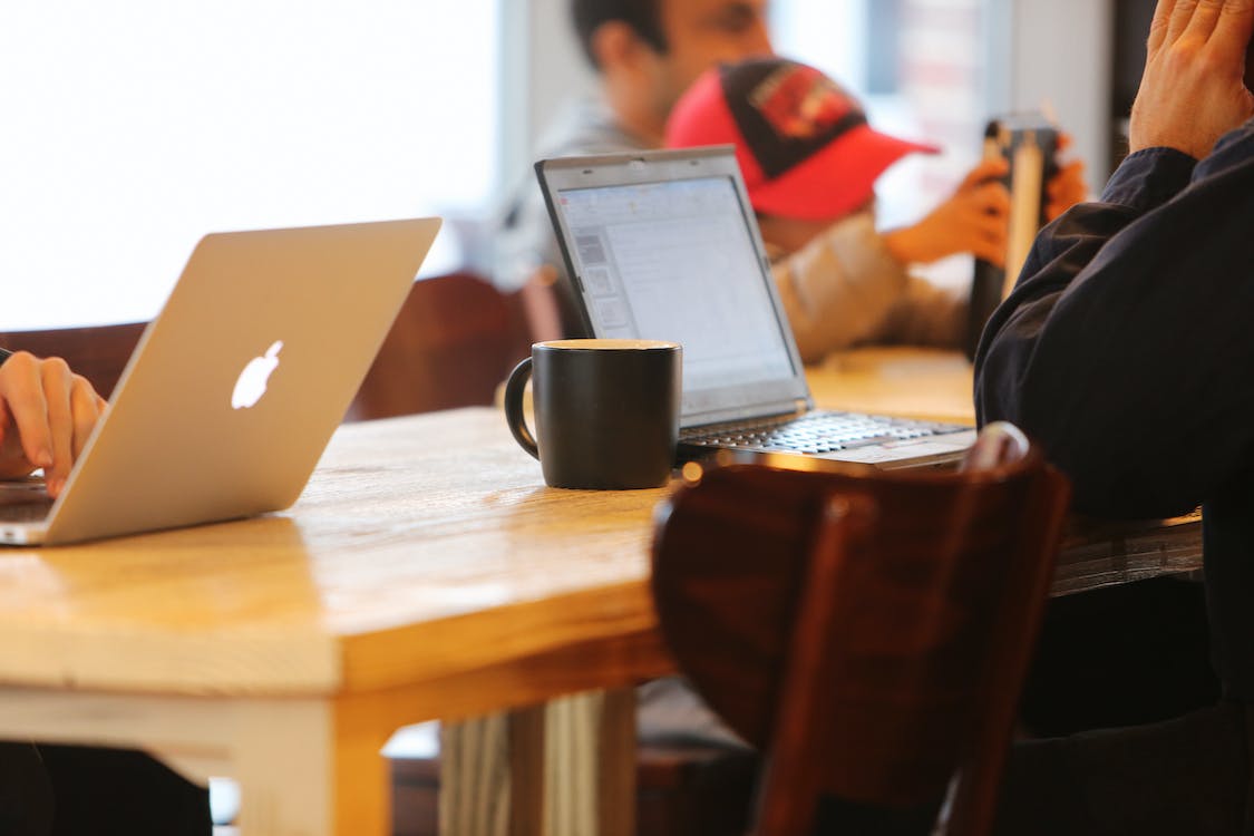 Free People Using Laptops While Sitting on Chair Stock Photo