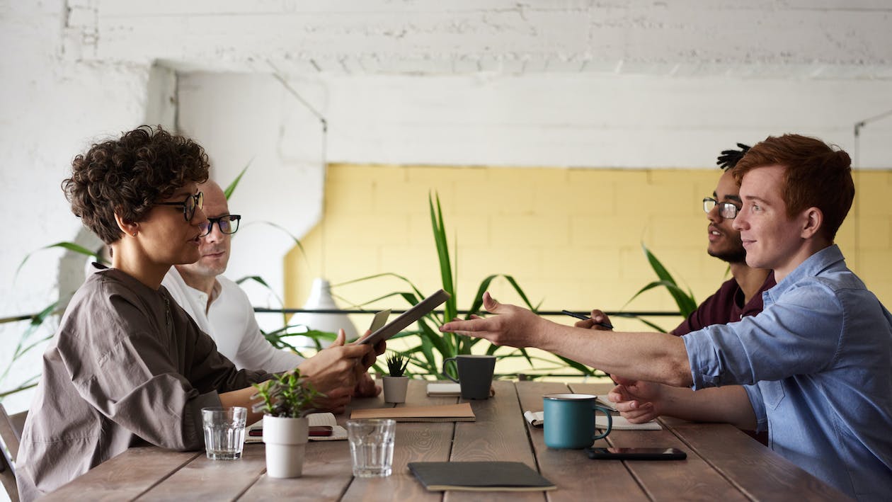 Free Photo Of People Near Wooden Table Stock Photo